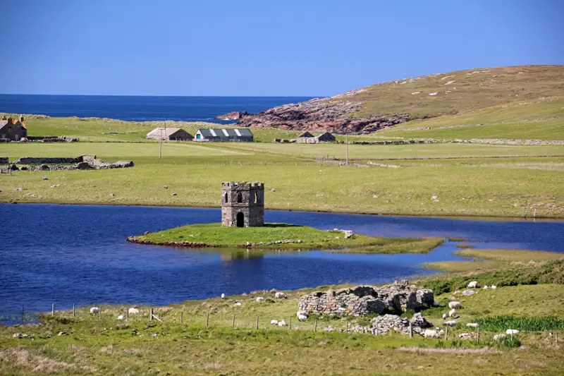 Scolpaig Tower stands on a small island on a sunny day
